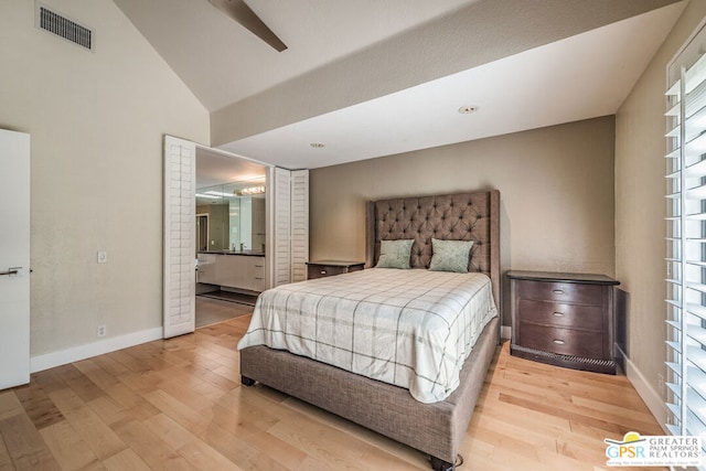 bedroom with ensuite bathroom, multiple windows, light hardwood / wood-style floors, and ceiling fan