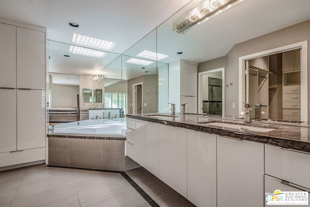 bathroom with vanity, independent shower and bath, and tile patterned floors