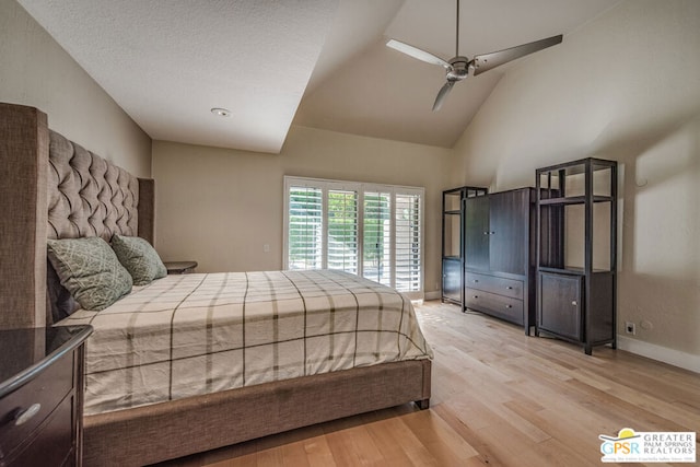 bedroom with vaulted ceiling, light hardwood / wood-style flooring, a textured ceiling, and ceiling fan