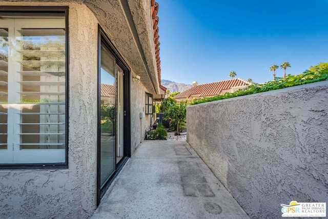 view of side of home with a mountain view