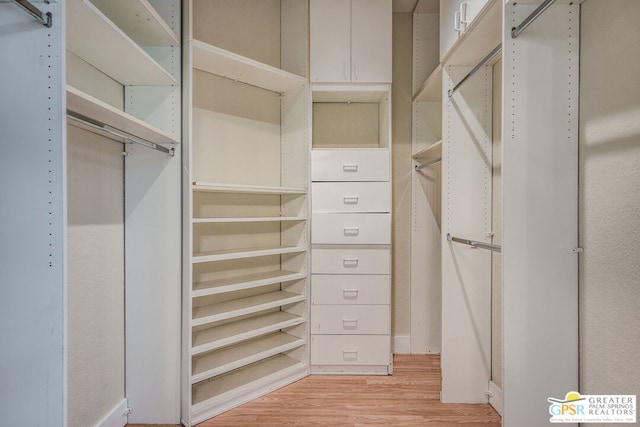 spacious closet featuring light hardwood / wood-style floors