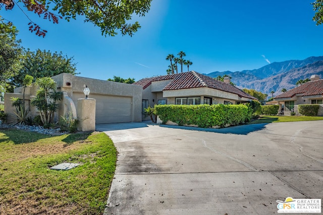 view of front of house with a mountain view and a garage