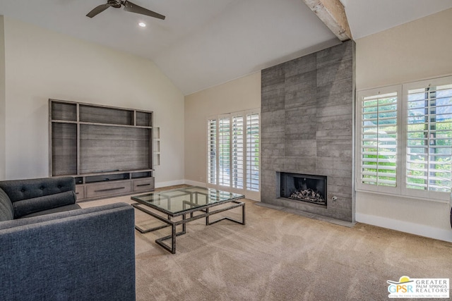 carpeted living room featuring a tile fireplace, lofted ceiling with beams, a healthy amount of sunlight, and ceiling fan