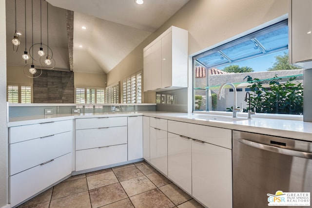 kitchen featuring vaulted ceiling, dishwasher, a wealth of natural light, and white cabinets