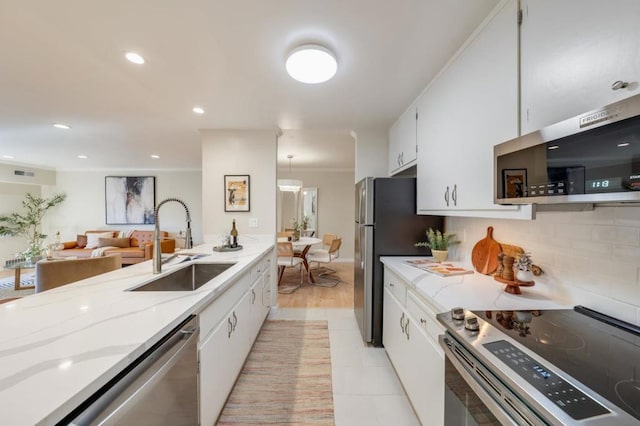 kitchen with backsplash, sink, white cabinetry, light tile patterned floors, and appliances with stainless steel finishes