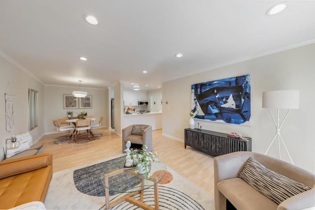 living room featuring light hardwood / wood-style flooring and ornamental molding