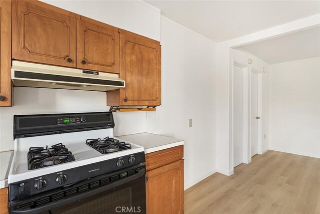 kitchen featuring light hardwood / wood-style floors and white gas stove