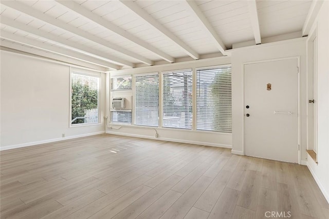 unfurnished sunroom featuring beam ceiling, wood ceiling, and plenty of natural light