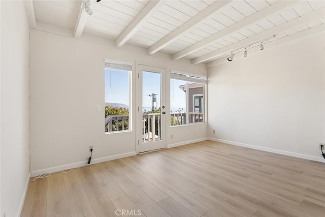 unfurnished room featuring light hardwood / wood-style flooring, beam ceiling, and wood ceiling