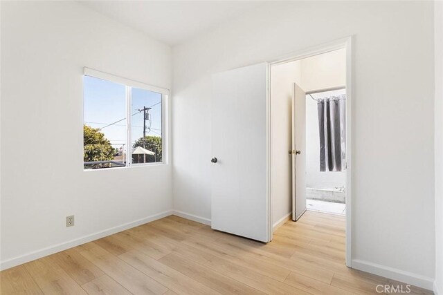 unfurnished room with light hardwood / wood-style flooring