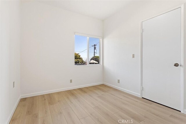 unfurnished room featuring light wood-type flooring