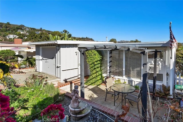 view of outbuilding featuring a pergola