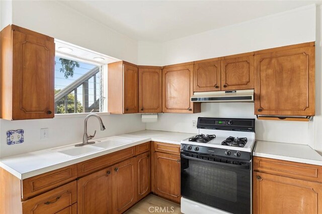 kitchen featuring sink and white gas range oven