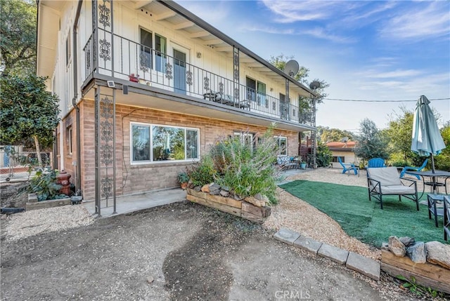 back of property with a patio and a balcony