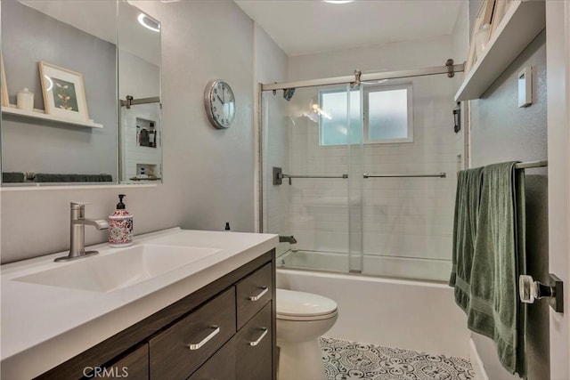 full bathroom featuring toilet, vanity, and bath / shower combo with glass door