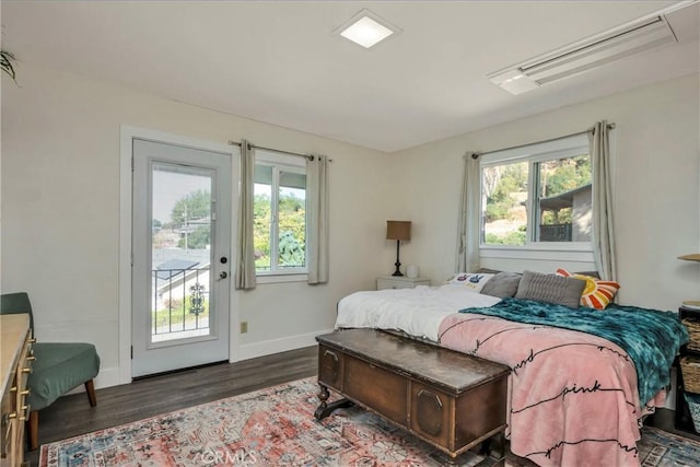 bedroom featuring access to outside and dark hardwood / wood-style floors