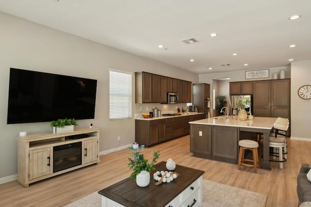 living room featuring light hardwood / wood-style flooring and sink