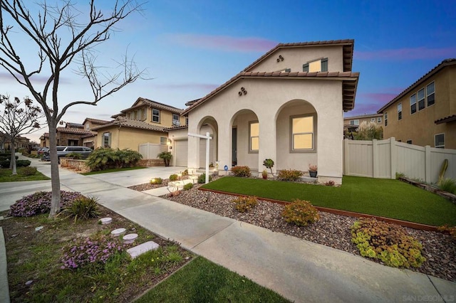 mediterranean / spanish-style home featuring a lawn