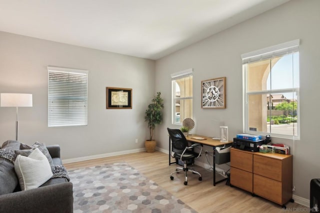 office area with light hardwood / wood-style floors