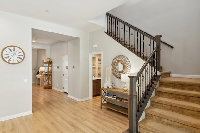 stairway with hardwood / wood-style floors