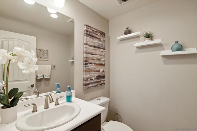 bathroom featuring vanity and toilet