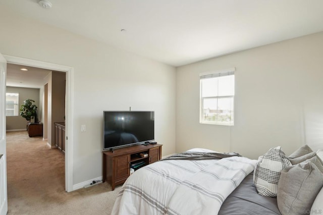 carpeted bedroom featuring multiple windows