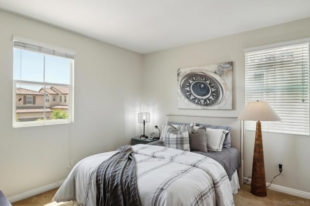 bedroom featuring light carpet