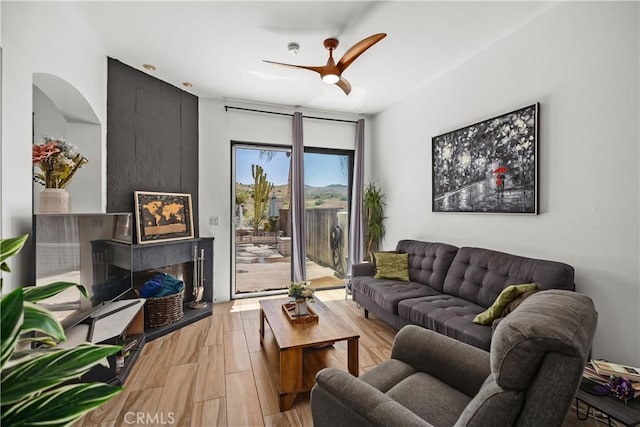 living room featuring wood-type flooring and ceiling fan