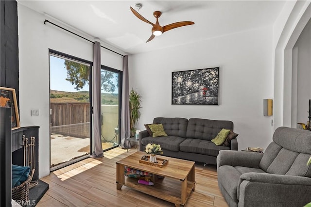 living room featuring ceiling fan and light wood-type flooring