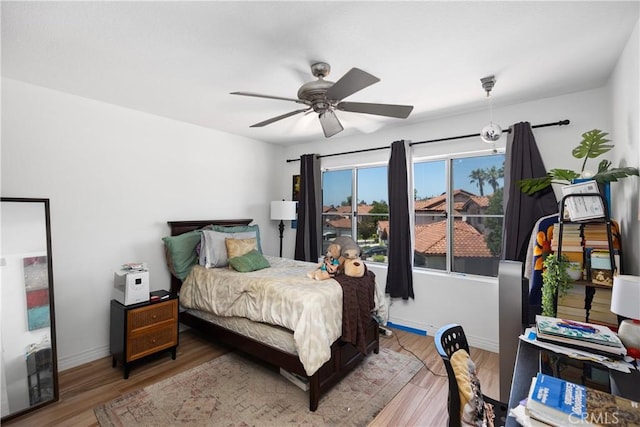 bedroom featuring hardwood / wood-style flooring and ceiling fan