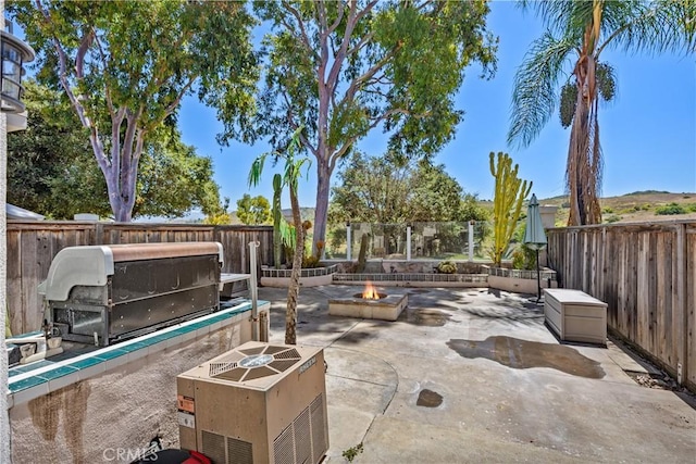 view of patio / terrace featuring an outdoor fire pit and a grill