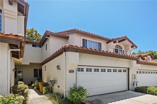 mediterranean / spanish house with a garage