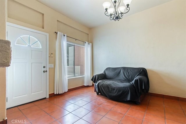 tiled foyer featuring a notable chandelier