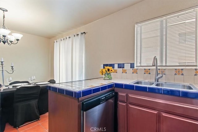 kitchen with sink, stainless steel dishwasher, a notable chandelier, tile countertops, and pendant lighting