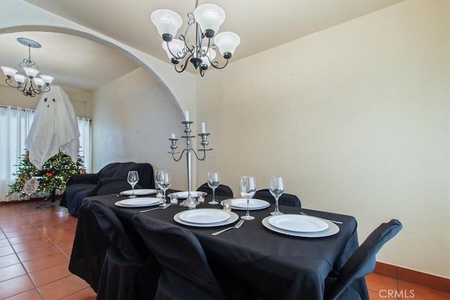 tiled dining area with a chandelier