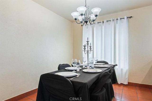 tiled dining area with a chandelier