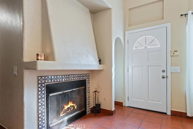 tiled foyer entrance featuring a fireplace