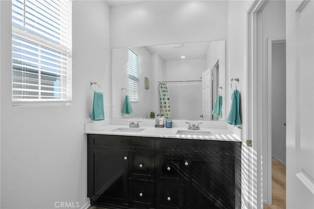 bathroom featuring vanity, a healthy amount of sunlight, and a shower with shower curtain