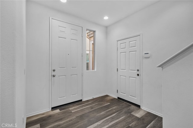 foyer entrance with dark hardwood / wood-style floors