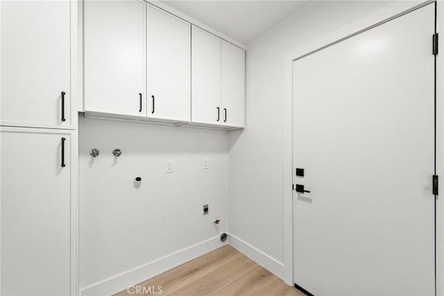 washroom featuring electric dryer hookup, light wood-type flooring, cabinets, gas dryer hookup, and washer hookup