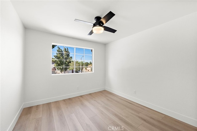 spare room with ceiling fan and light wood-type flooring