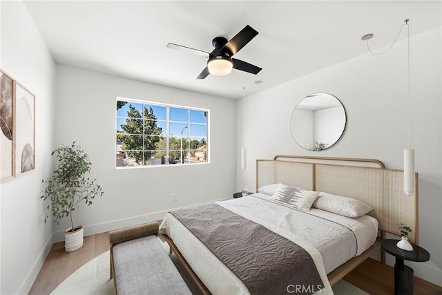 bedroom with ceiling fan and hardwood / wood-style flooring