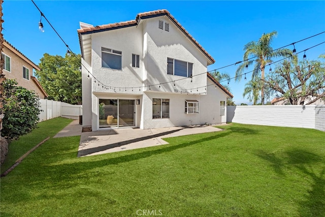 back of property featuring a lawn and a patio