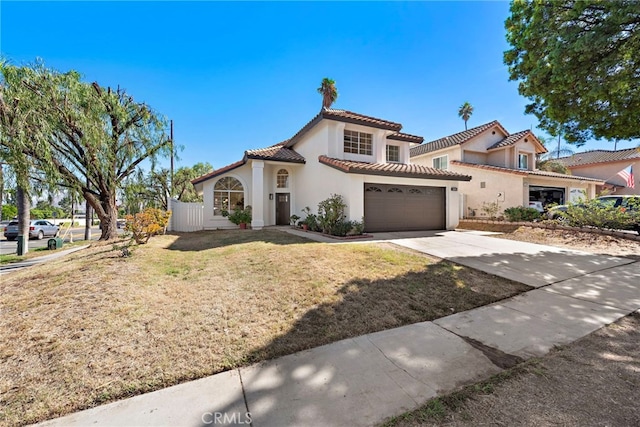 mediterranean / spanish house with a front yard and a garage