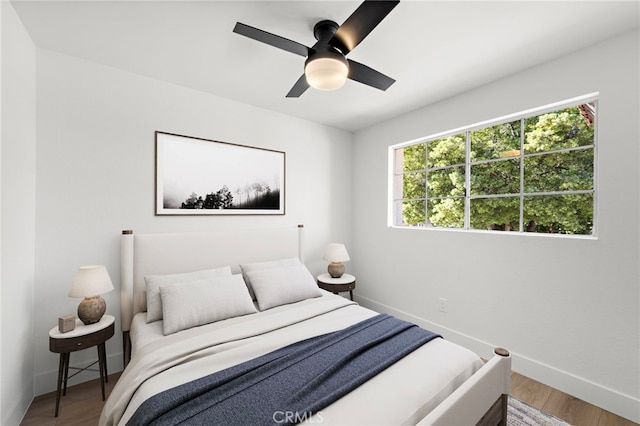 bedroom featuring hardwood / wood-style floors and ceiling fan