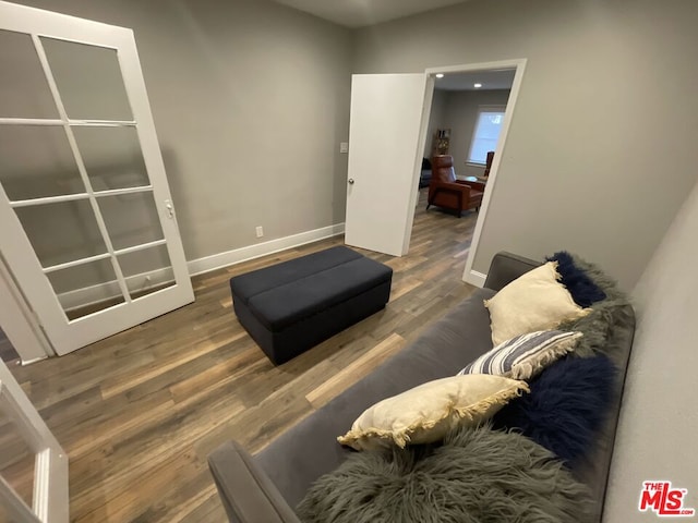 sitting room with dark wood-type flooring