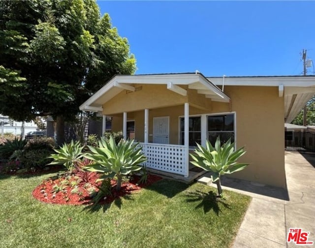 bungalow-style house with a porch and a front lawn