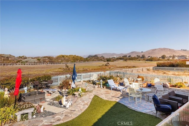 view of yard with a mountain view, a rural view, and a patio