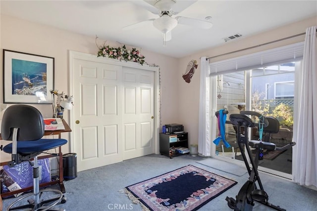 workout area featuring carpet and ceiling fan