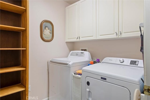 laundry area with cabinets and washer and clothes dryer